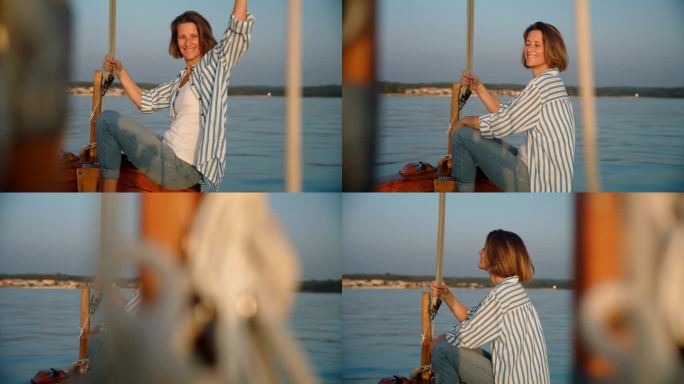SLO MO海岸奥德赛:女子从帆船上挥手，在傍晚的阳光下驶向一个岛屿