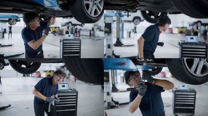 男机械师在汽车修理厂修理汽车起落架