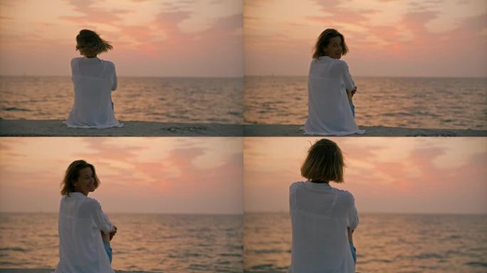 SLO MO海滨日落:一个女人安静地坐在码头上，欣赏着令人惊叹的海上日落