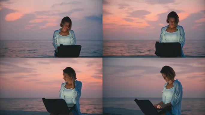 SLO MO海滨工作空间:一名女子坐在蓝色时间的码头上用笔记本电脑工作