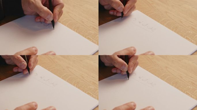 写遗嘱草稿的特写镜头。男人用左手在一张纸上写字，然后把纸收起来，重新开始。静态特写镜头，高角度。