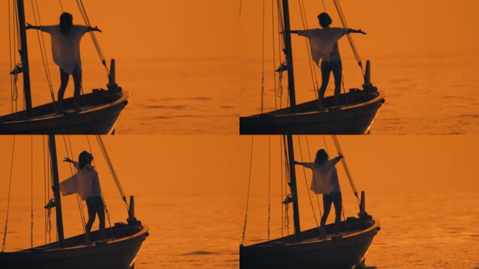 宁静的航行:一个女人站在船首，伸开双臂，凝视着夕阳