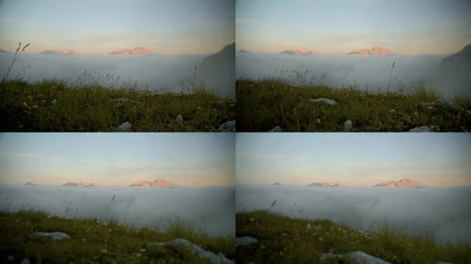 风景秀丽，山峰在雾之上，后面是草山