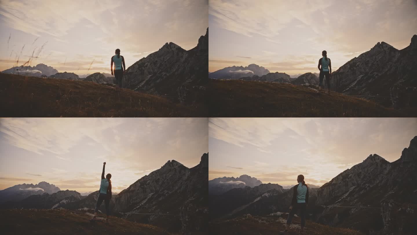 日出时，在风景秀丽的山岭上欢呼的女性慢跑者