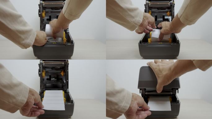 近距离人手插入条形码不干胶或标签不干胶或热敏色带卷条形码打印到条形码打印机。