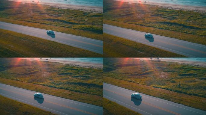 空中经典汽车太阳耀焰黄金时间浪漫海滩驱动器日落无人机拍摄1940普利茅斯4K
