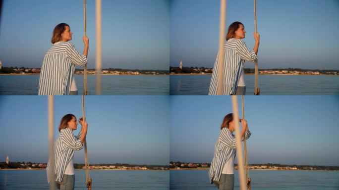 海岸奥德赛:一名女子在一艘驶向海岸美丽岛屿的船上欣赏风景