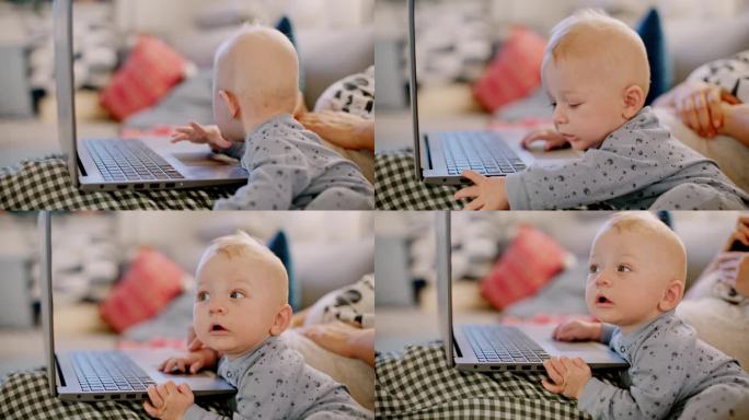 好奇的小婴儿和妈妈在家里使用笔记本电脑