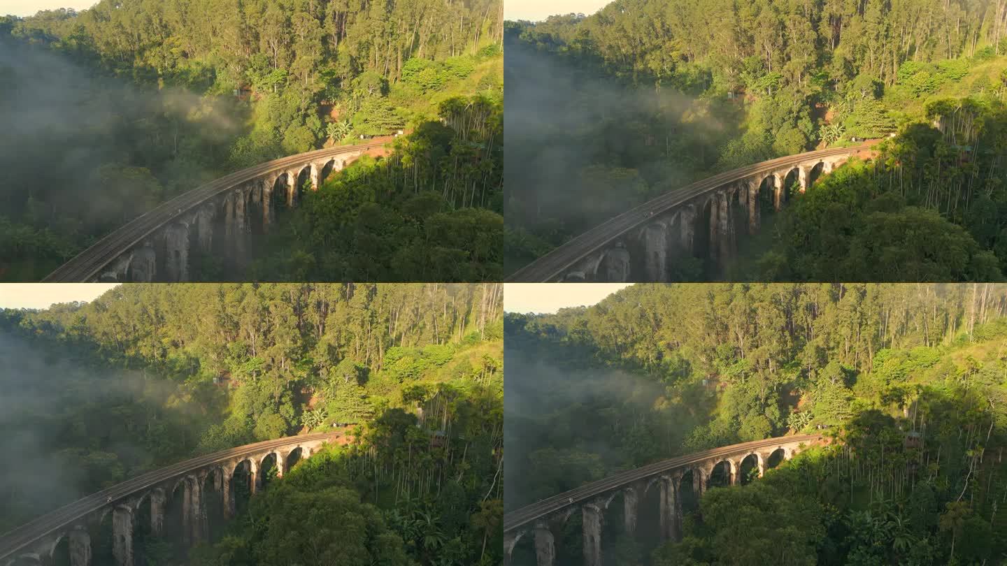 在晴朗和雾蒙蒙的早晨，在斯里兰卡艾拉建立9个拱门桥的空中无人机拍摄