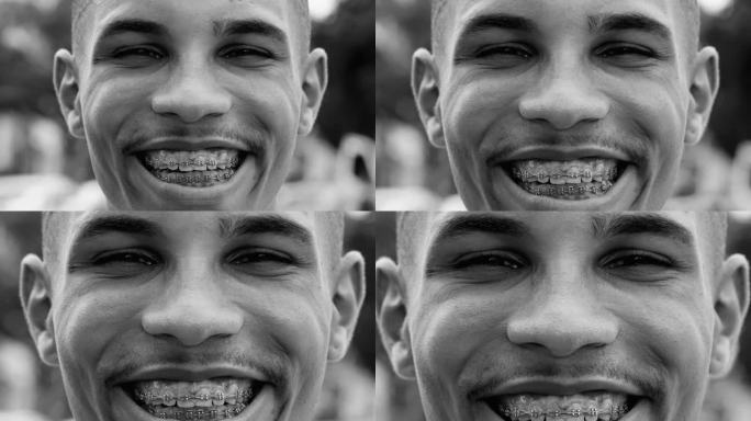 一个快乐的年轻黑人盯着相机在艺术黑白单色剪辑。快乐的表现者眼睛对视