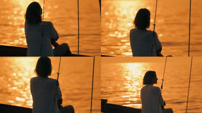 SLO MO航行宁静:一名女子在甲板上欣赏日落