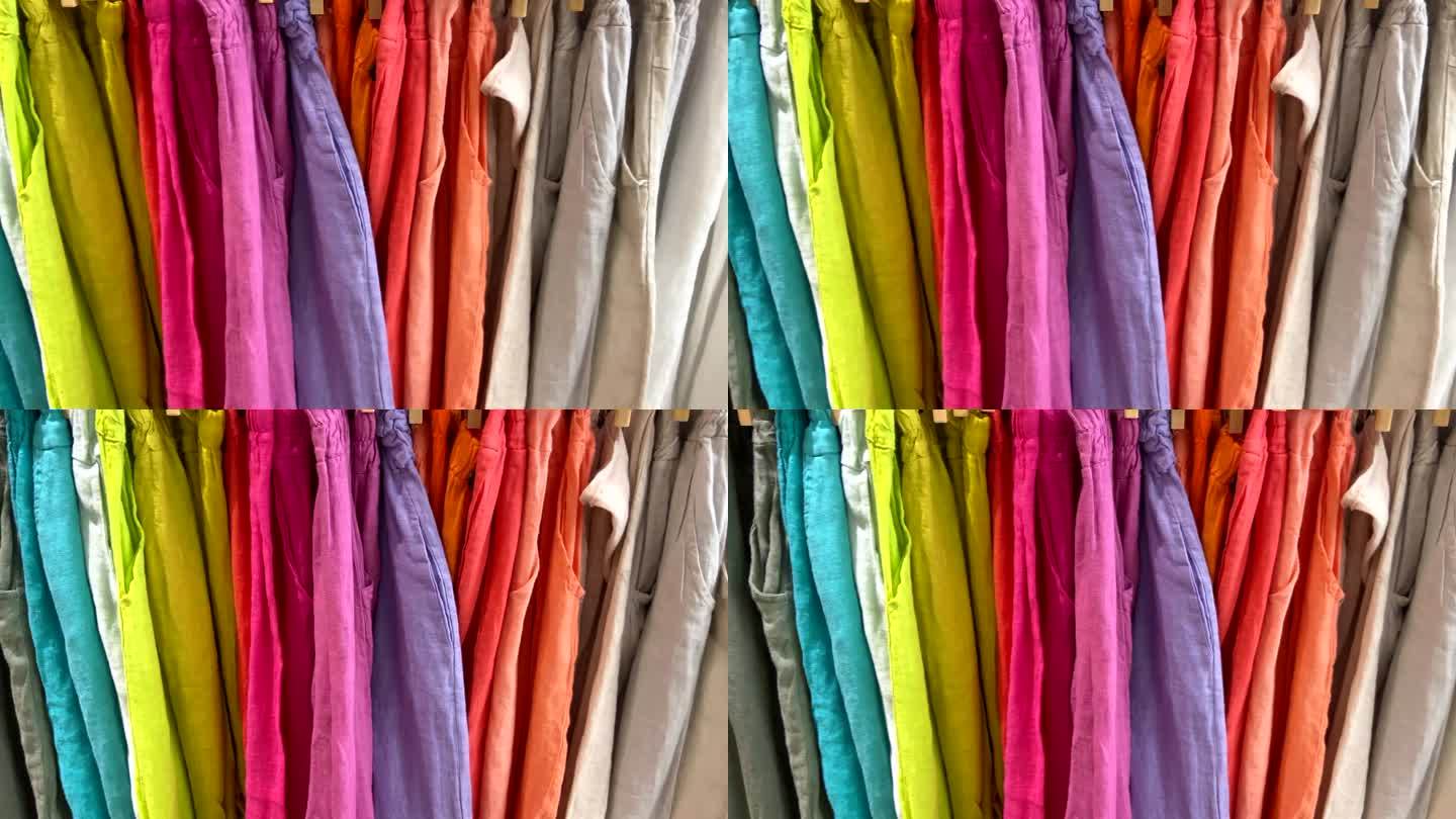 在一家纺织品商店里，五颜六色的织物衣服。购物、工业、销售理念。