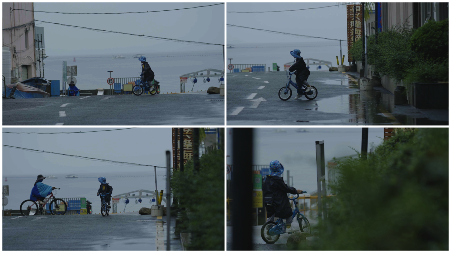 下雨天小男孩骑自行车