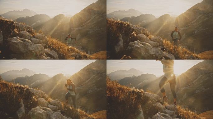 日出时，一名女子在阳光明媚的雄伟山脉上慢跑