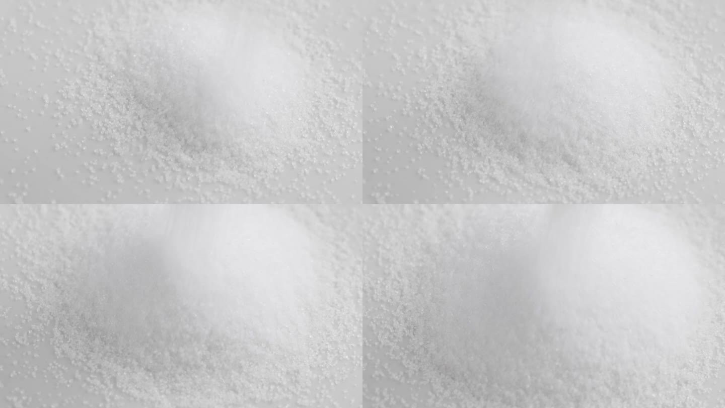 甜菊糖粉倒在白色甜味剂堆上的慢镜头特写
