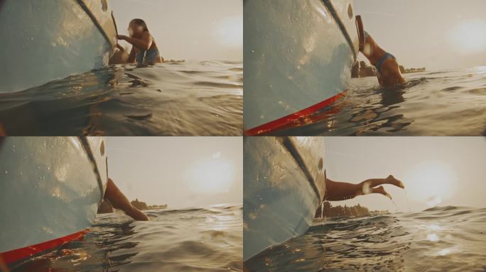 黄昏潜水:一名女子在日落时分跳入大海后爬上一艘渔船