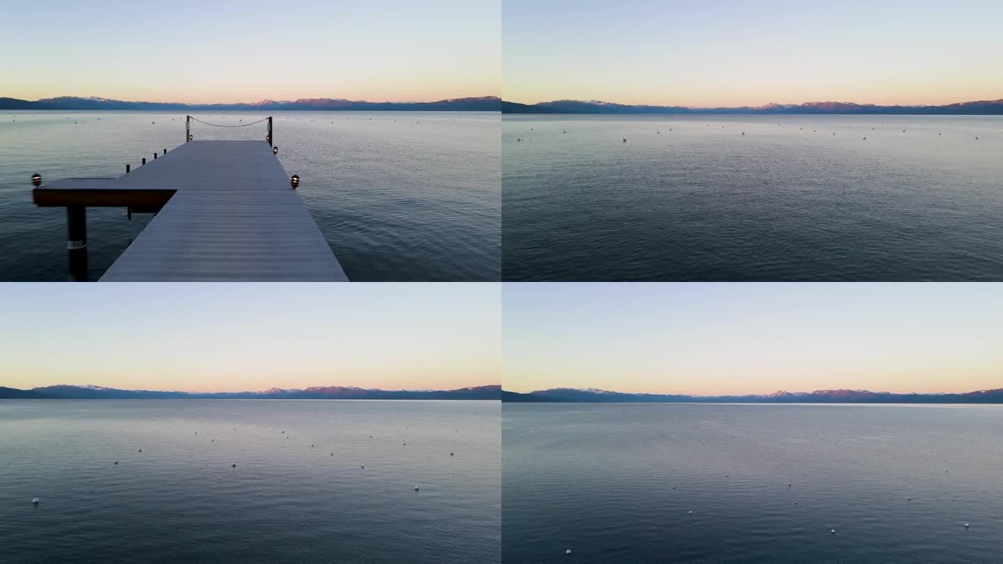 低空飞行，4K无人机在一个船坞上拍摄，一直延伸到加州的太浩湖。镜头从海岸线开始，然后向前移动到码头的