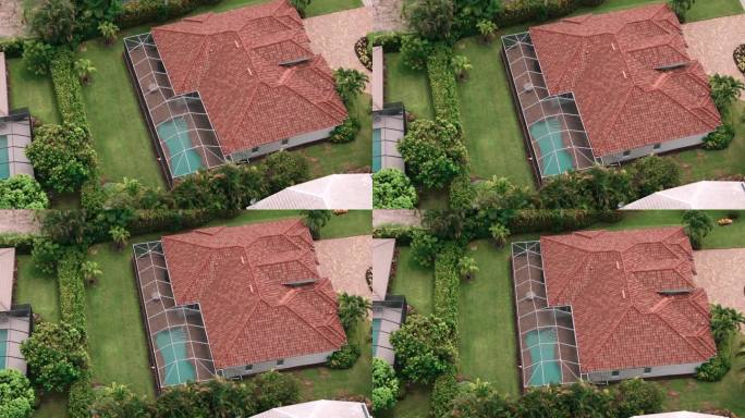 空中俯瞰佛罗里达房子里泳池的广阔视野。自顶向下移动镜头