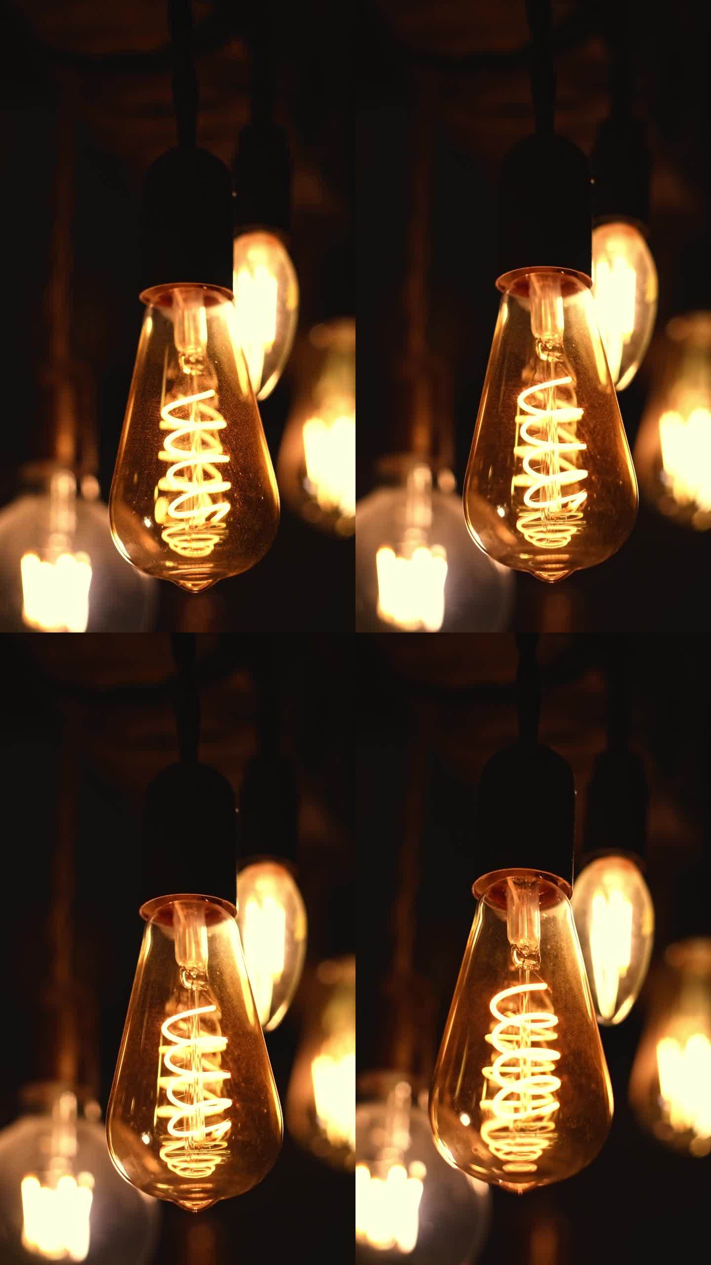 螺旋复古灯泡挂在黑暗的背景。电,古董