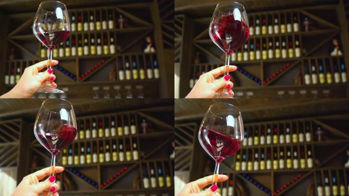红酒被漂亮地倒入玻璃杯中。酒保把红酒倒进杯子里。葡萄酒的生产和销售。