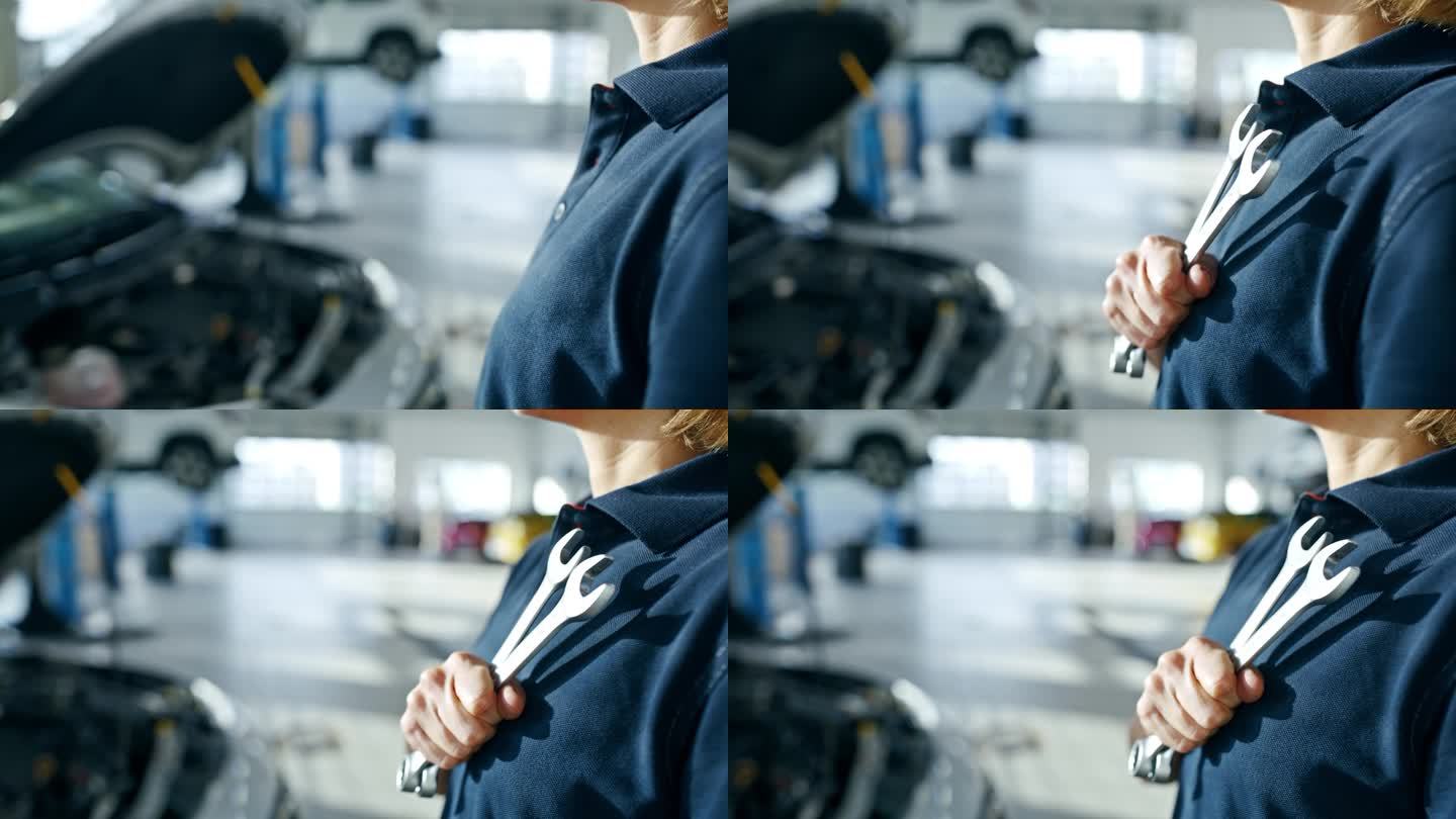 近景:女机械师在维修车间拿着扳手