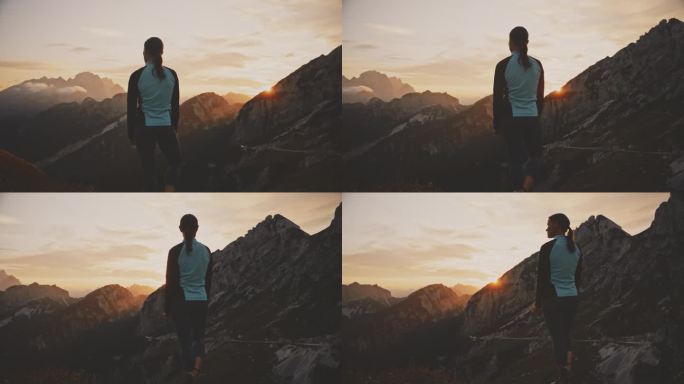 女跑步者在看山脉上的日出
