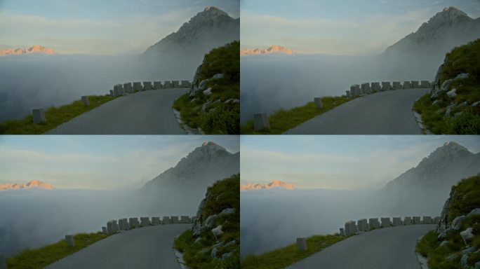 空灵的雾笼罩着公路后面山峰下的山谷