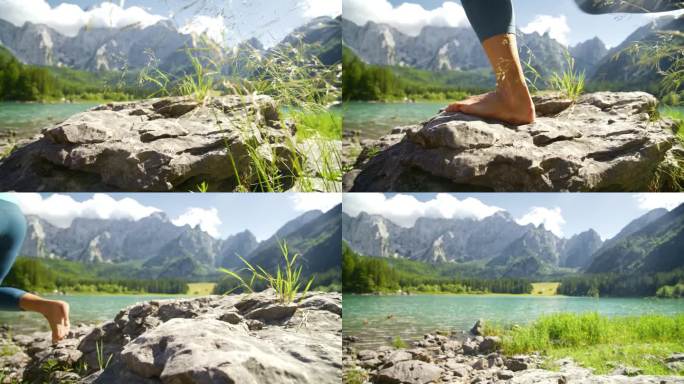 赤脚的女人踩在阳光明媚的湖边的岩石上