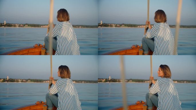 《海岸奥德赛》:一名女子坐在船头，欣赏着美丽的海岸