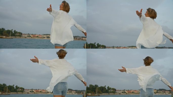 克罗地亚，欢快的女游客站在帆船上，张开双臂迎着天空