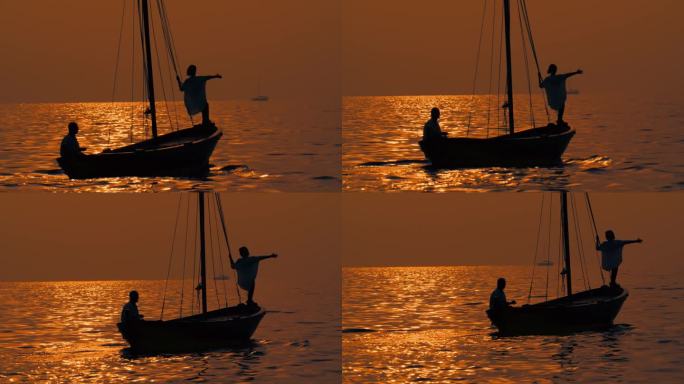 SLO MO海岸奥德赛:一对夫妇在日落时在木船上滑行的浪漫之旅