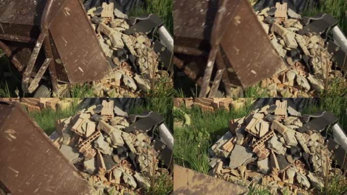 一个人从手推车上卸下石头和垃圾的静态镜头。