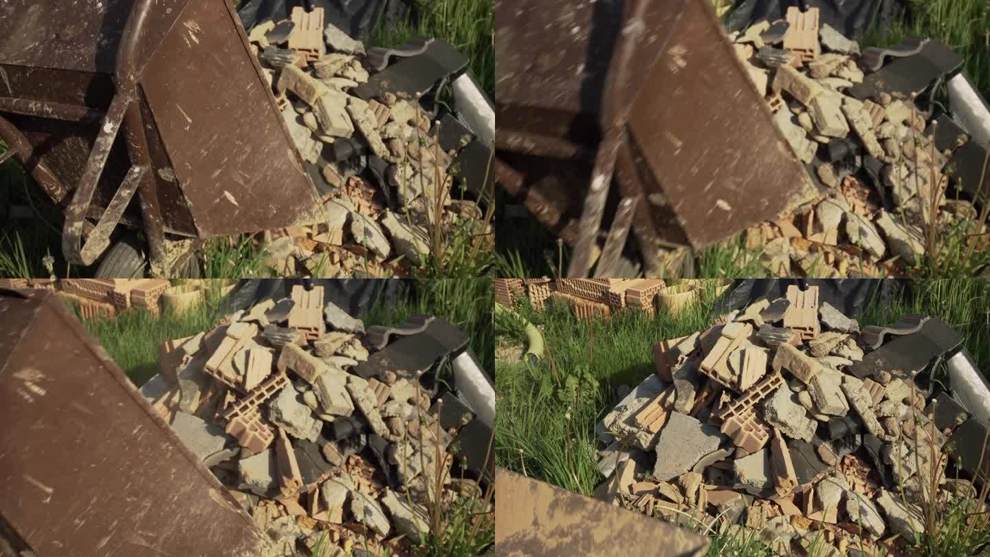 一个人从手推车上卸下石头和垃圾的静态镜头。