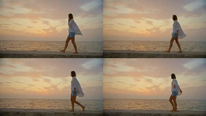 SLO MO海滨漫步:日落时码头上的女人的孤独漫步