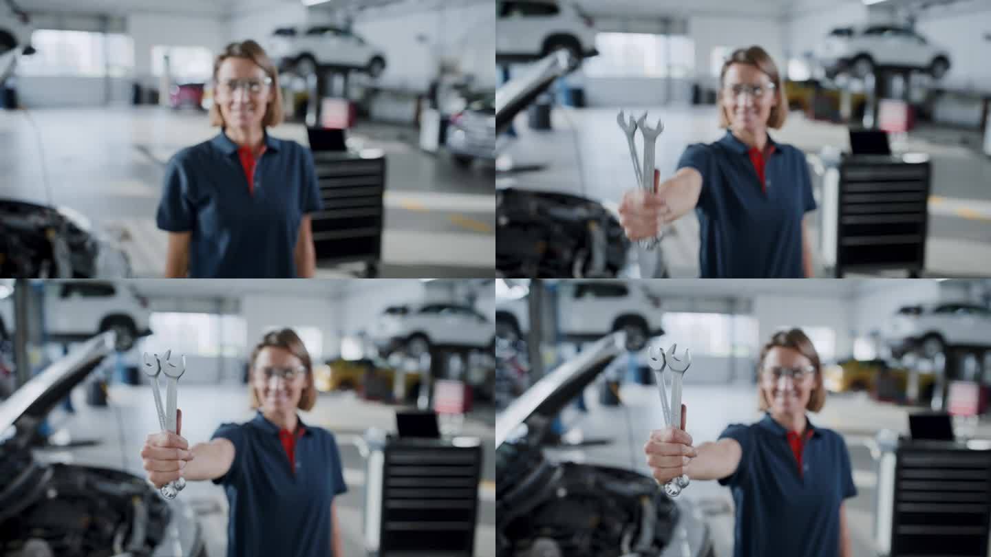 照片:自信的女汽车修理工在修理店拿着扳手