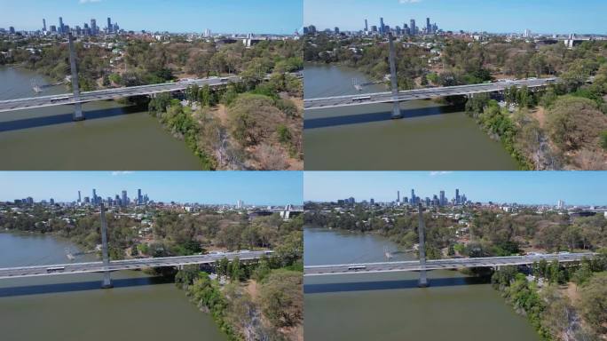 埃莉诺·舍内尔横跨澳大利亚昆士兰州布里斯班河的大桥。布里斯班天际线在遥远的背景。航拍左图