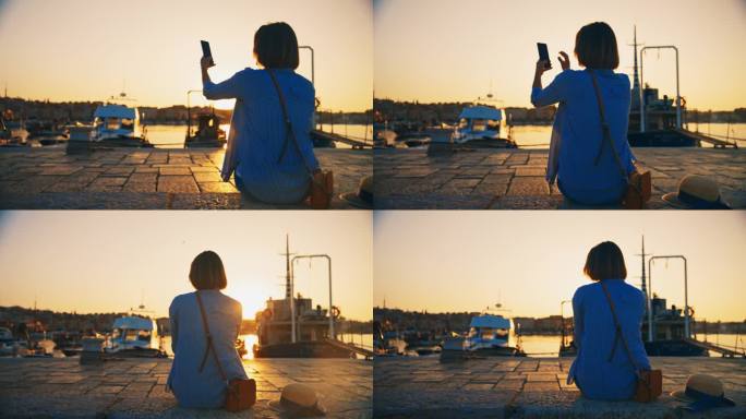 拍摄宁静:女人用手机拍摄码头上的日出