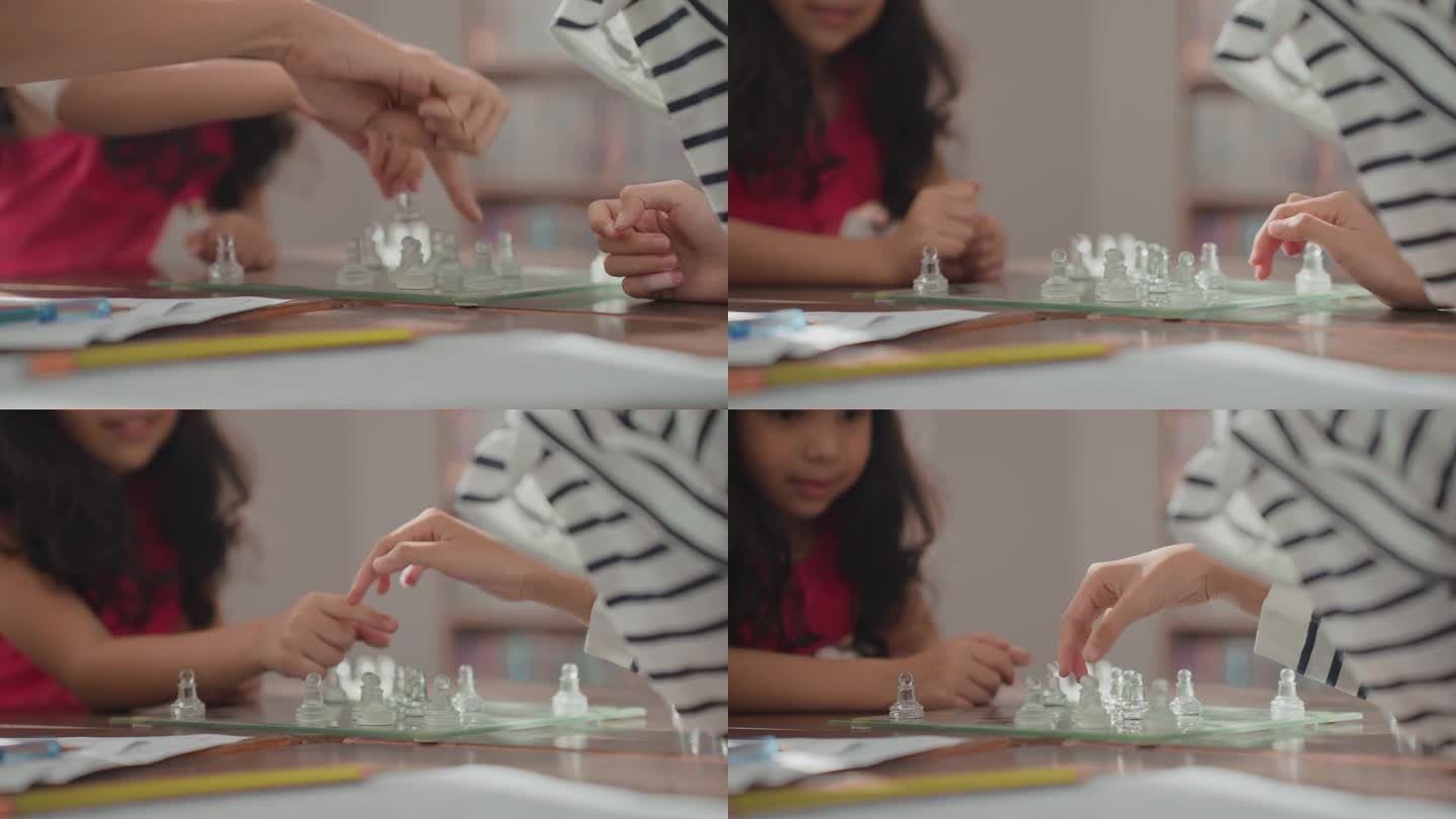 多种族小学生，两个小女孩在亚洲老师的监督下，在教室里一起玩跳棋，练习创造力、策略和冥想。