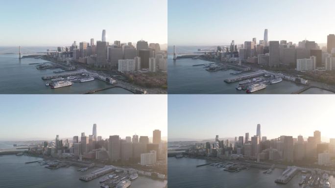 现代城市天际线鸟瞰图。在这段航拍视频中，俯瞰旧金山市中心，海湾大桥和这座城市的建筑奇迹沐浴在夕阳的温