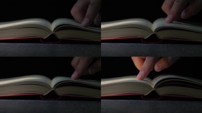 一只手在一本旧书上的特写，一位老人的手指沿着一本档案书的线条移动。有选择性的重点。休闲读书。一个老人