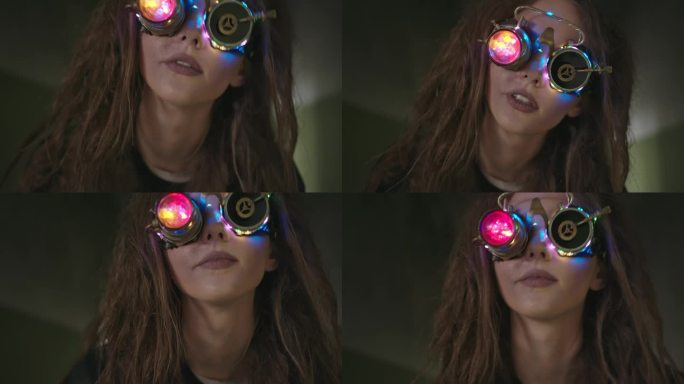 戴着蒸汽朋克VR眼镜体验虚拟现实的女人。头发凌乱的疯狂女科学家戴着发光的VR眼镜探索虚拟现实