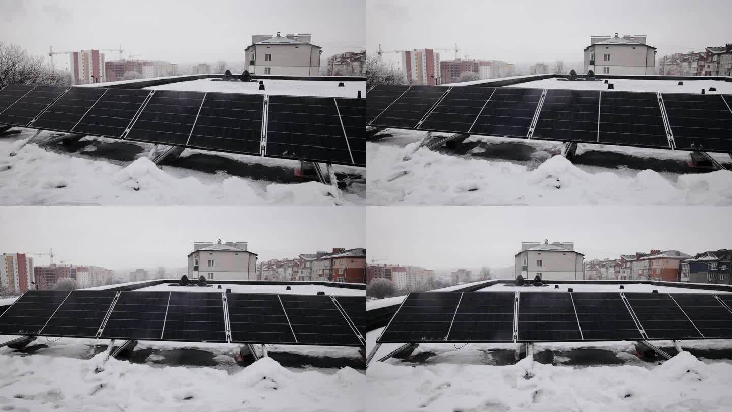 在冬季，建筑的屋顶上安装了几块太阳能电池板。可再生能源生产概念