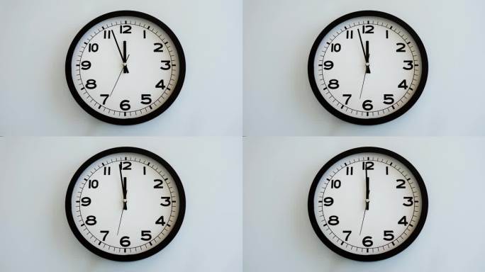 白色壁钟上的白色钟面特写，箭头显示12:00或00:00