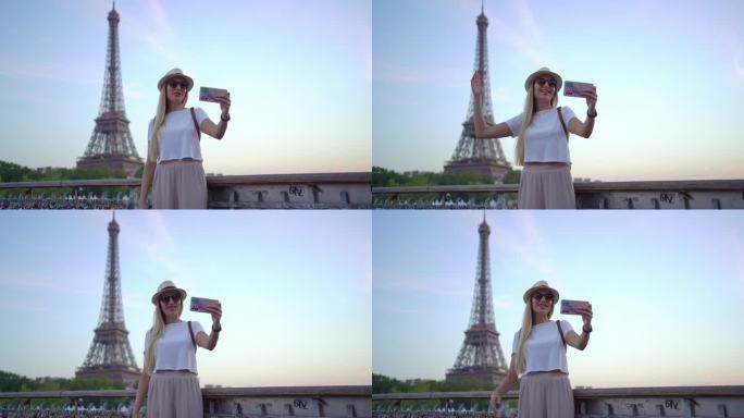 一个快乐的女人在巴黎埃菲尔铁塔前进行视频通话