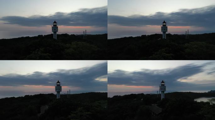 航拍夕阳下涠洲岛南湾鳄鱼山景区灯塔