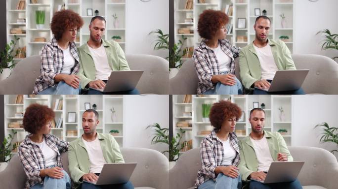 一对快乐的年轻非裔美国夫妇在一起观看社交媒体上的流媒体视频时微笑着，玩得很开心。放松的女士和先生在周