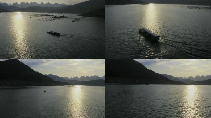 航拍在夕阳下的贵州安龙万峰湖游船