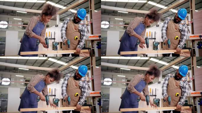 两个成年非洲木匠在车间里用电钻在木板上打洞，以制作新家具。熟练的同事，穿着防护工作服，在制造和工艺方