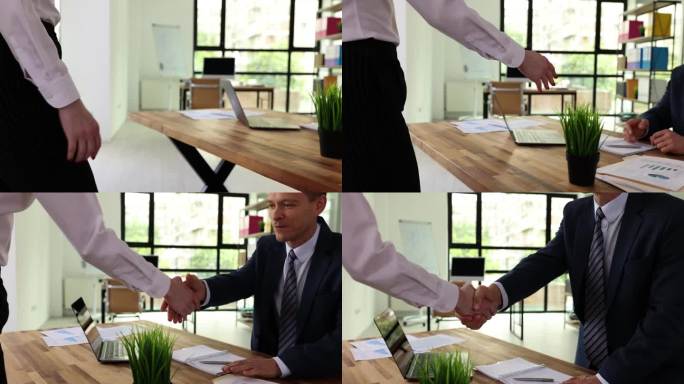 男女在办公室开会时握手