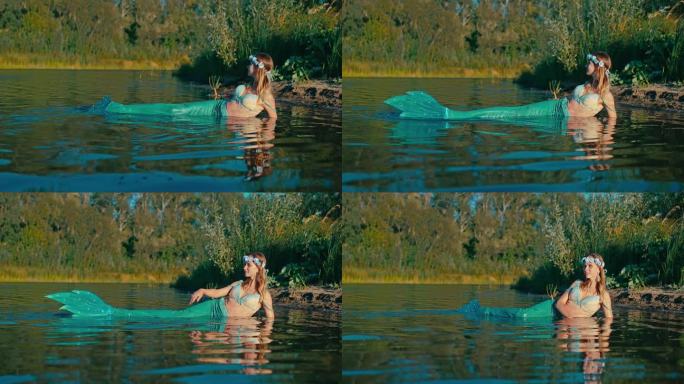 迷人美丽的鲁萨尔卡与大鱼尾躺在浅水河岸，肖像4K，普罗斯